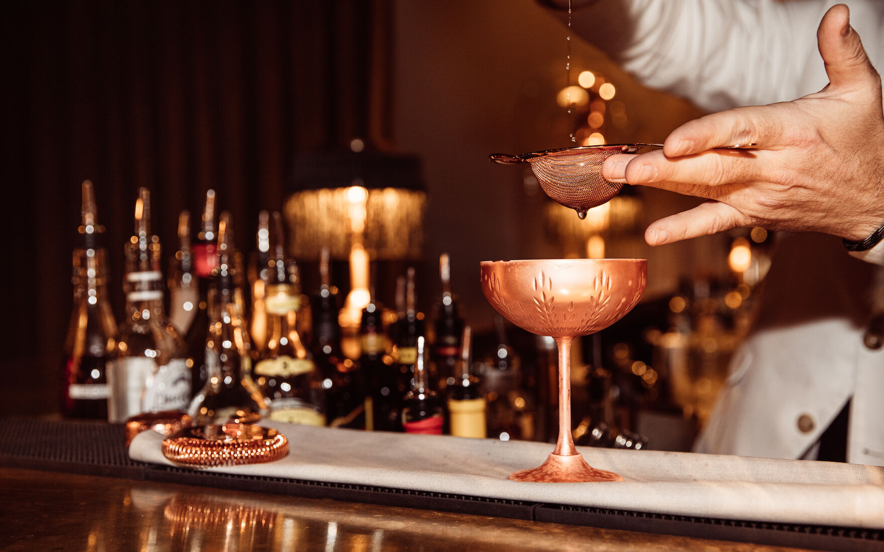 Gastwerk Hotel Hamburg Mangold Bar 33 Barkeeper gießt Drink durch Strainer in der Mangold Bar im Gastwerk Hotel