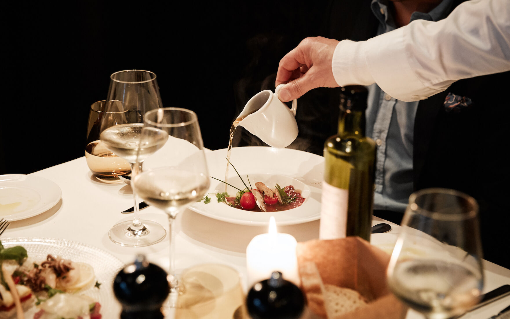 Staff pouring broth over dish at DaCaio restaurant