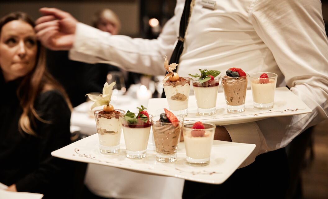 Various desserts being served by staff at DaCaio