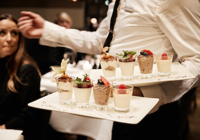 Various desserts being served by staff at DaCaio