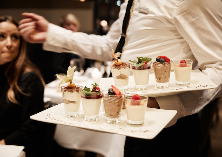 The George Hotel Hamburg Restaurant Dacaio food 58 Various desserts being served by staff at DaCaio