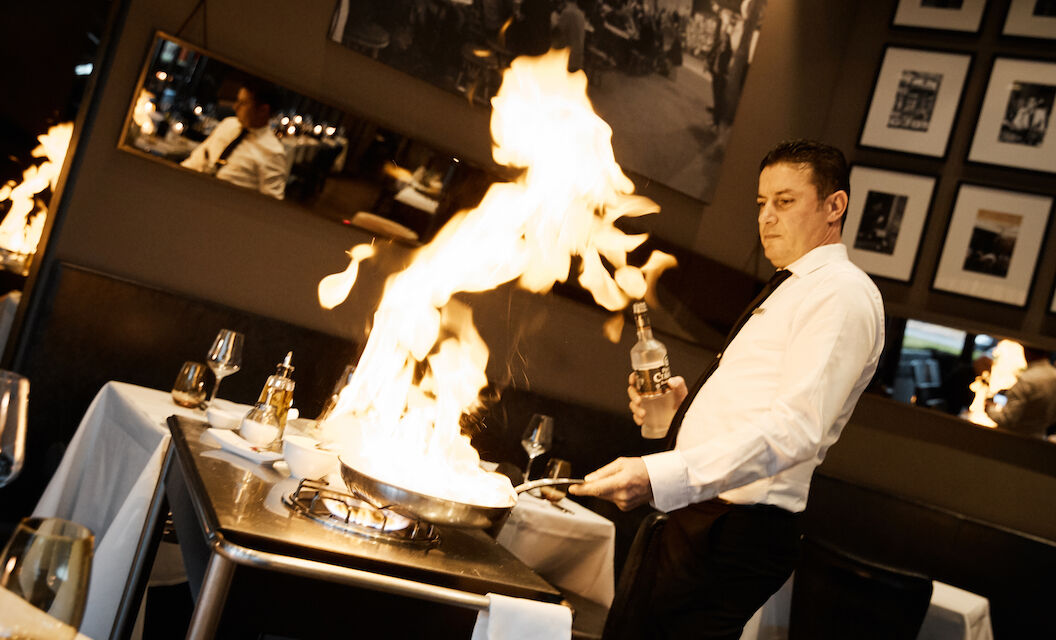 Scampi being flambéed by waiter at DaCaio restaurant