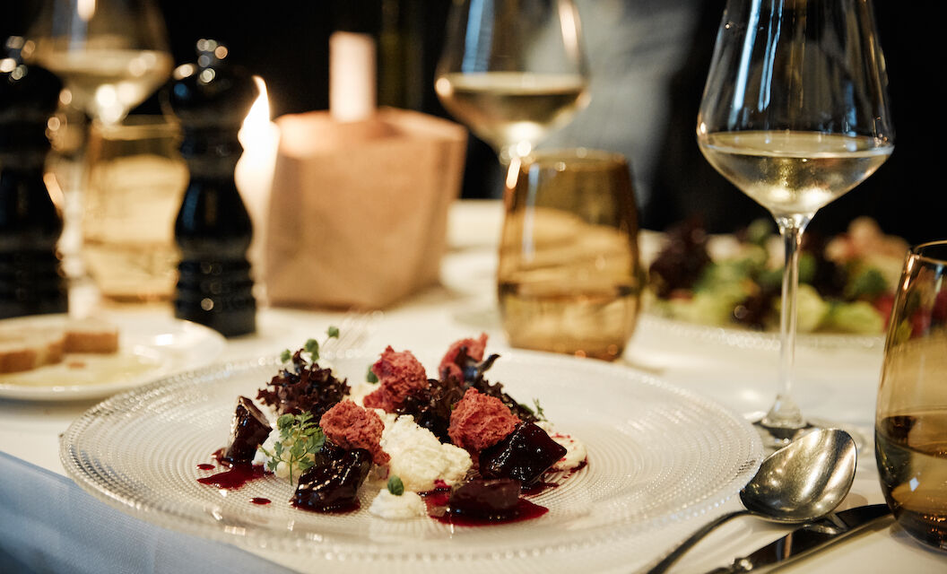 Close up of burrata in the background a wine glass