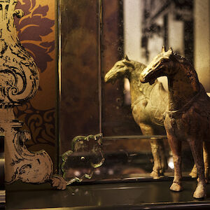 Wooden horse in front of a mirror displayed as decor in the Library