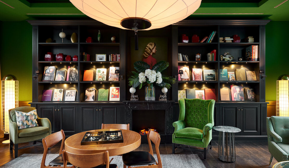 Meeting room Private Library with green armchair and books in the background