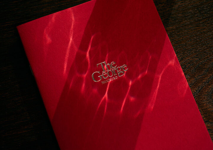 Notebook with The George logo illuminated by sunlight