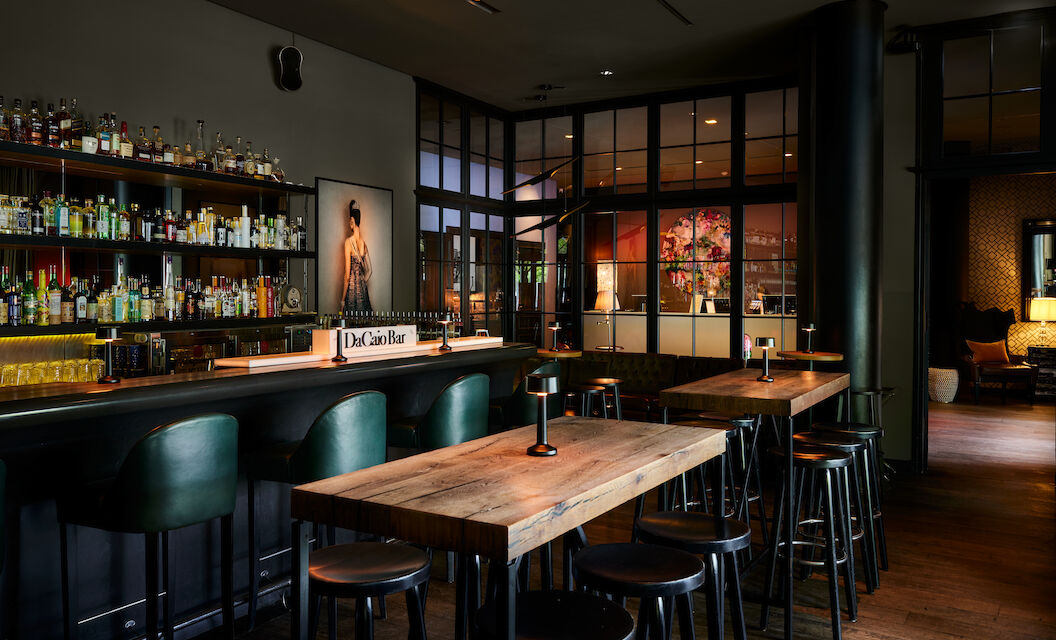 High tables in front of the bar with lobby view behind