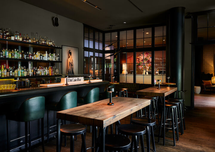 High tables in front of the bar with lobby view behind
