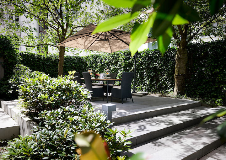 A garden next to the private library, featuring a large table