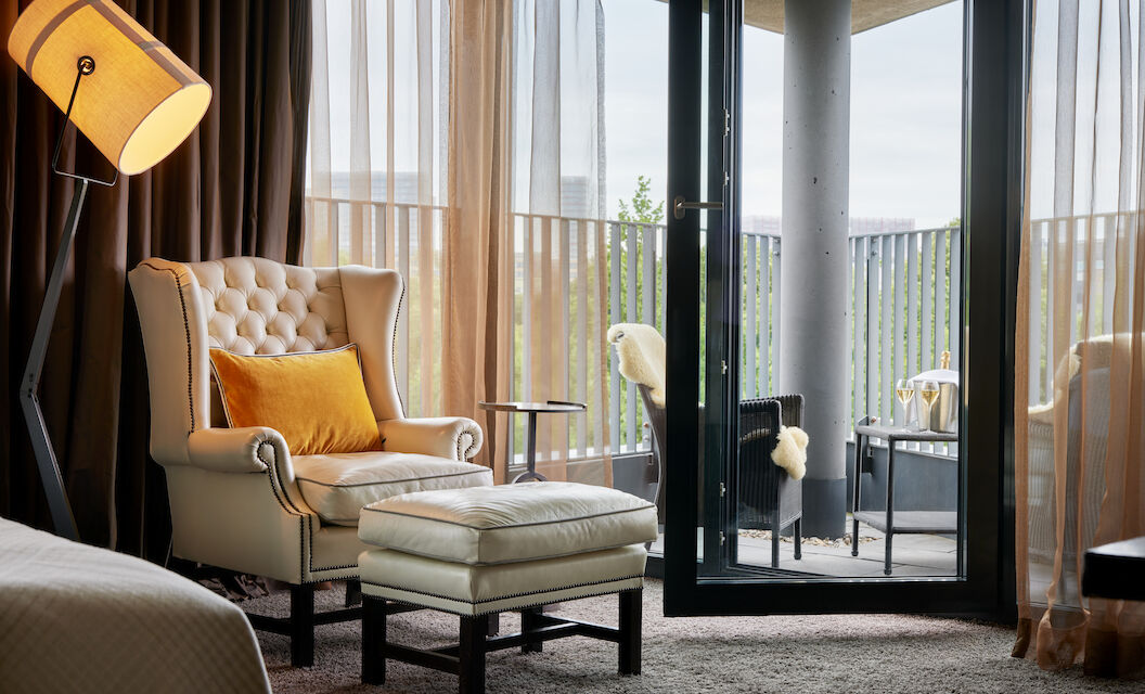 The George Hotel Hamburg Zimmer Juniorsuite 04 Chesterfield armchair with footstool, pointed balcony with seating behind