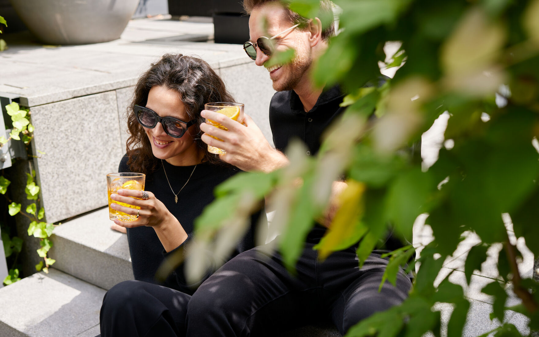 A Couple enjoys drinks in The George Garden