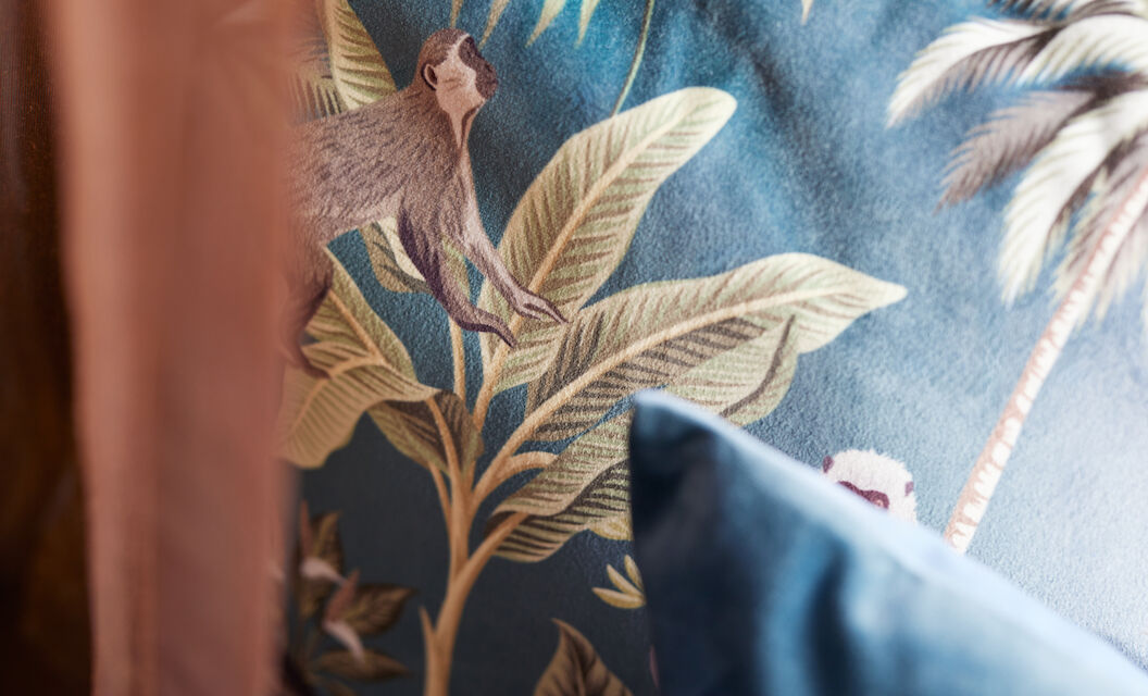 The George Hotel Hamburg Zimmer S Room 011 Close-up of a cushion featuring plants and monkeys