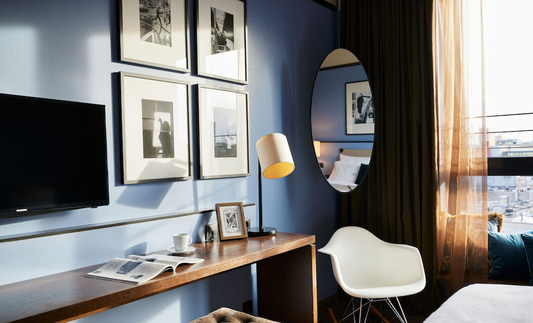 The George Hotel Hamburg Zimmer S Room 02 Room corner with wall art, narrow table, and Eames armchair