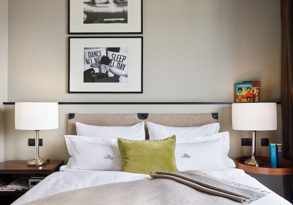 Double bed in room with Alster lake view, two decorative pictures on the wall