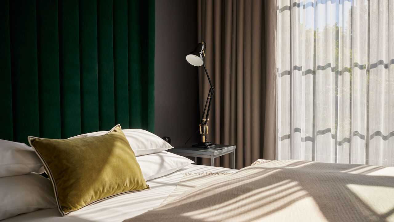 Gastwerk Hotel Hamburg M Loft Superior 03 Sonnenschein fällt durch die großen Fenster auf das Bett im Loft